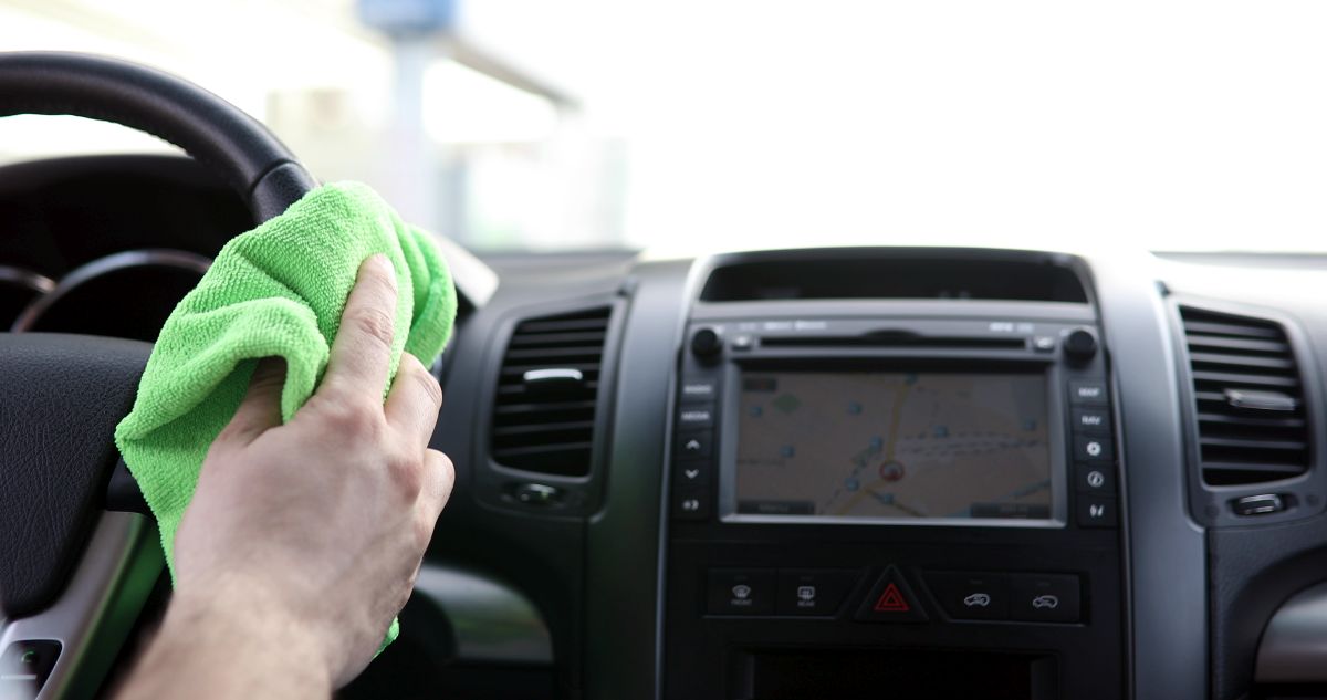 Cleaning car steering wheel with microfiber cloth